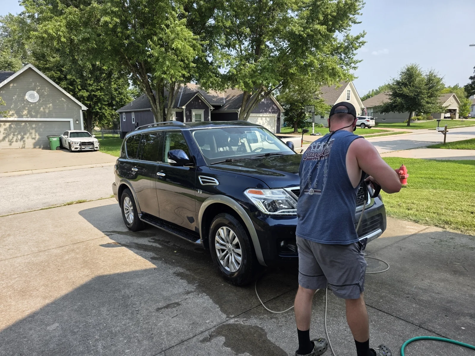 Double P washing a customer SUV in a driveway