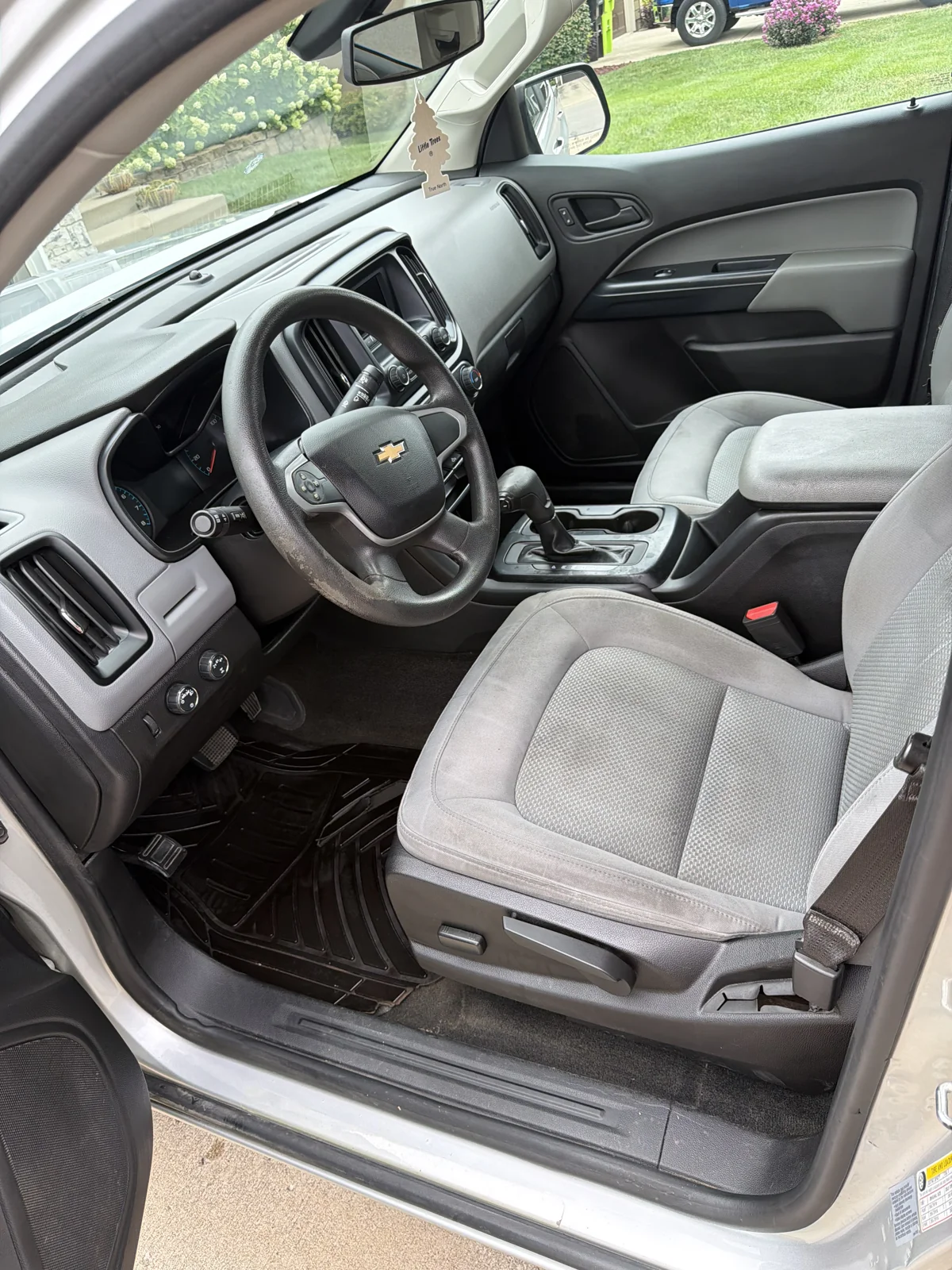 Same pickup driver area after detailing with cleaner upholstery, mat and dashboard